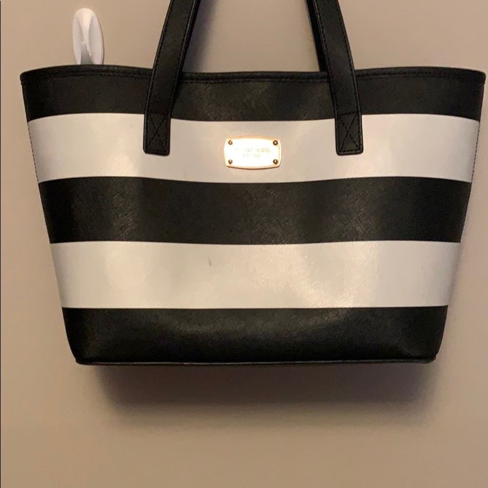 Michael Kors black and white striped handbag.